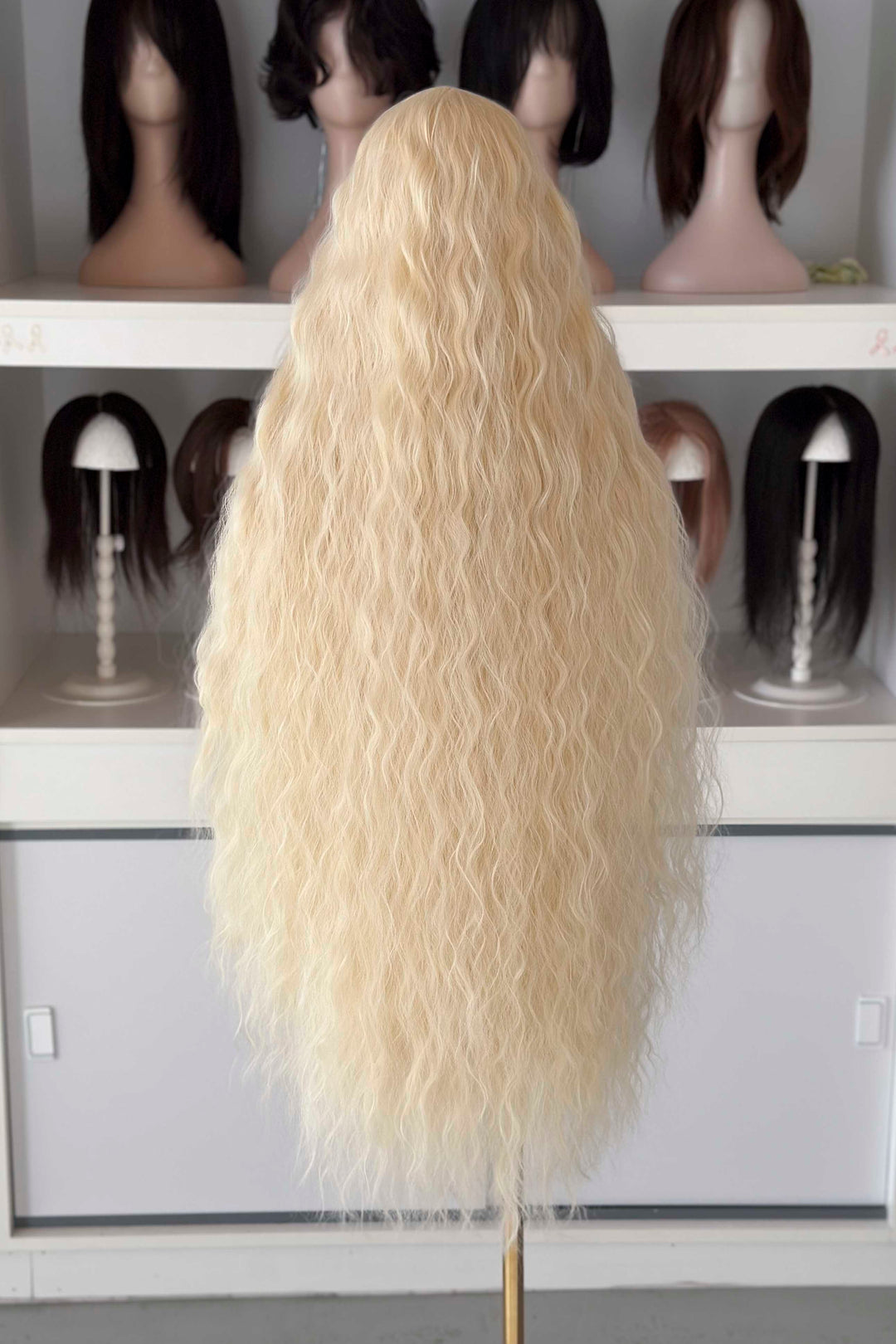 Back and front view of 40 inch extra long icy platinum blonde wavy wig with bangs on a mannequin.