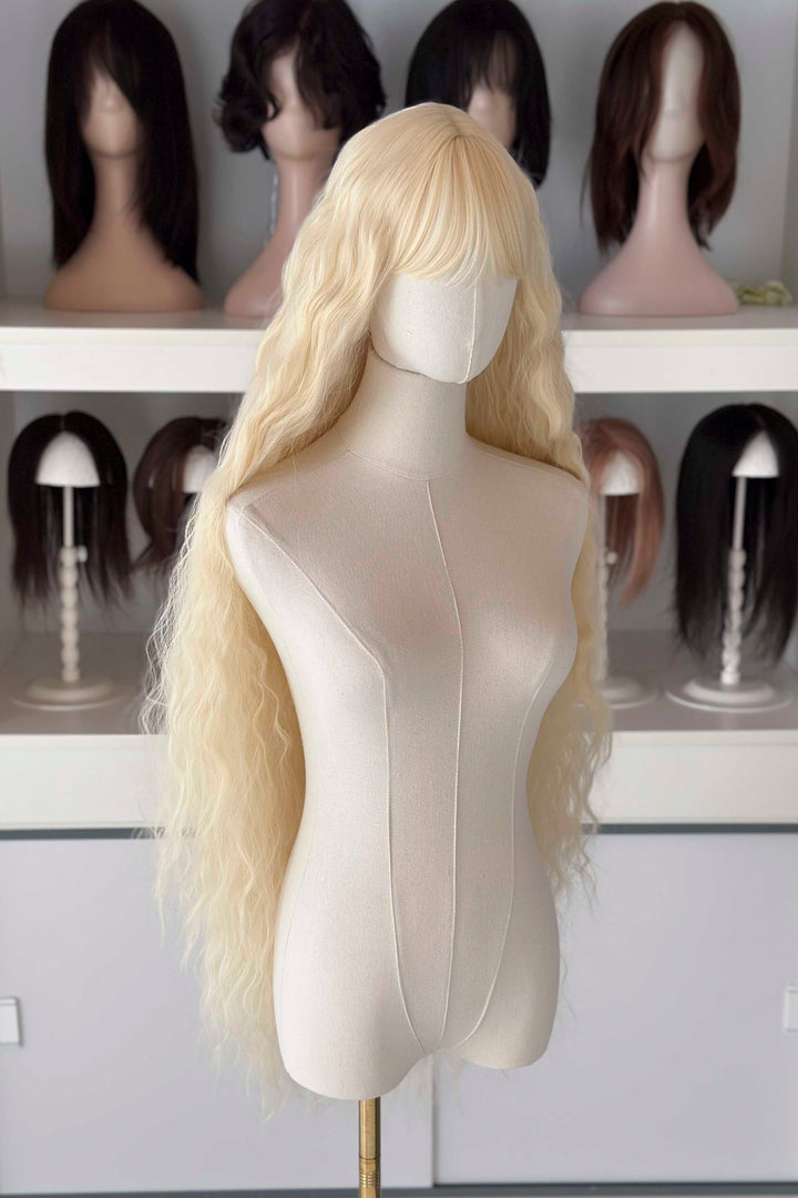 Back and front view of 40 inch extra long icy platinum blonde wavy wig with bangs on a mannequin.