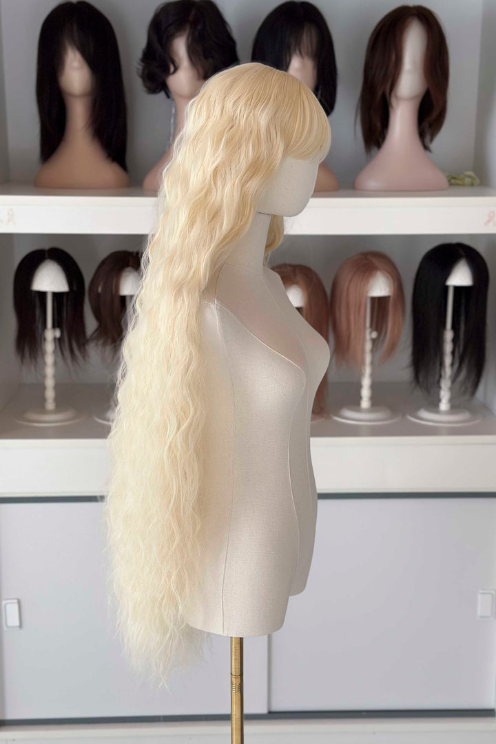 Back and front view of 40 inch extra long icy platinum blonde wavy wig with bangs on a mannequin.