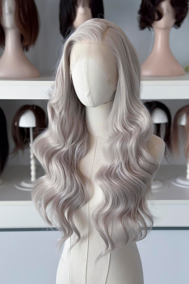 Silver lace front wig on a mannequin head with blurred wig display in the background