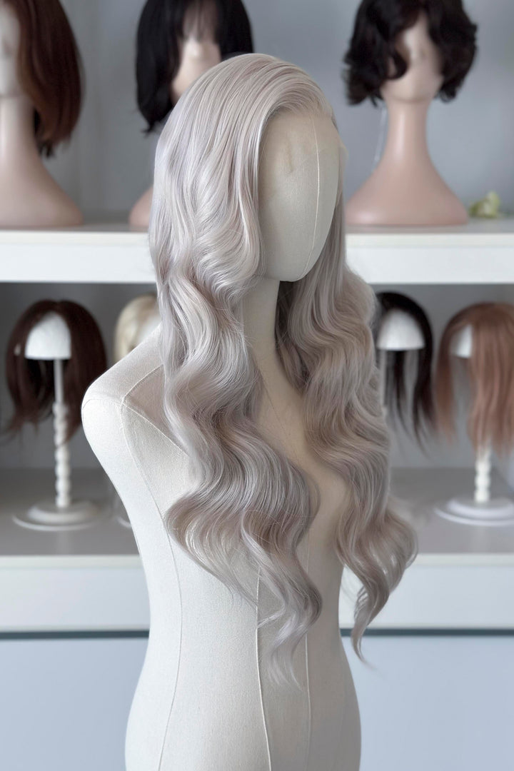 Silver lace front wig on a mannequin head with blurred wig display in the background