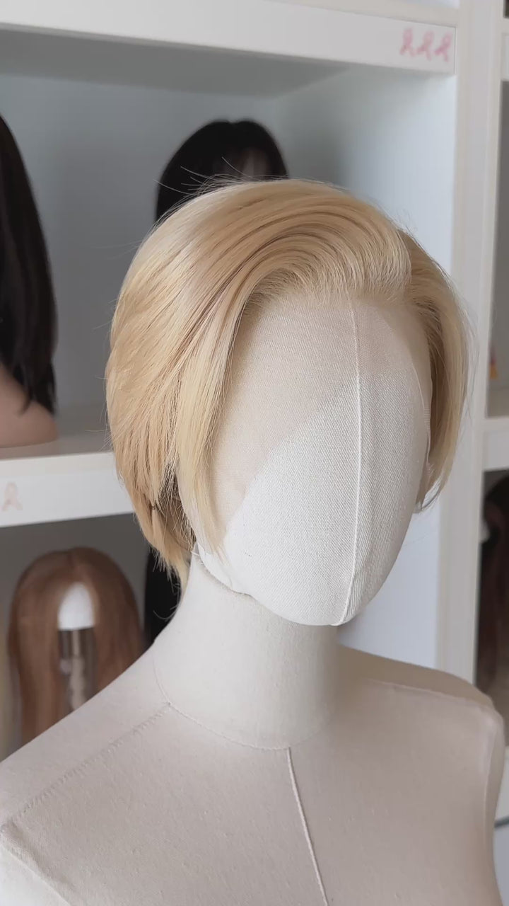 Blonde Short Lace wig on a mannequin head with blurred wig display in the background