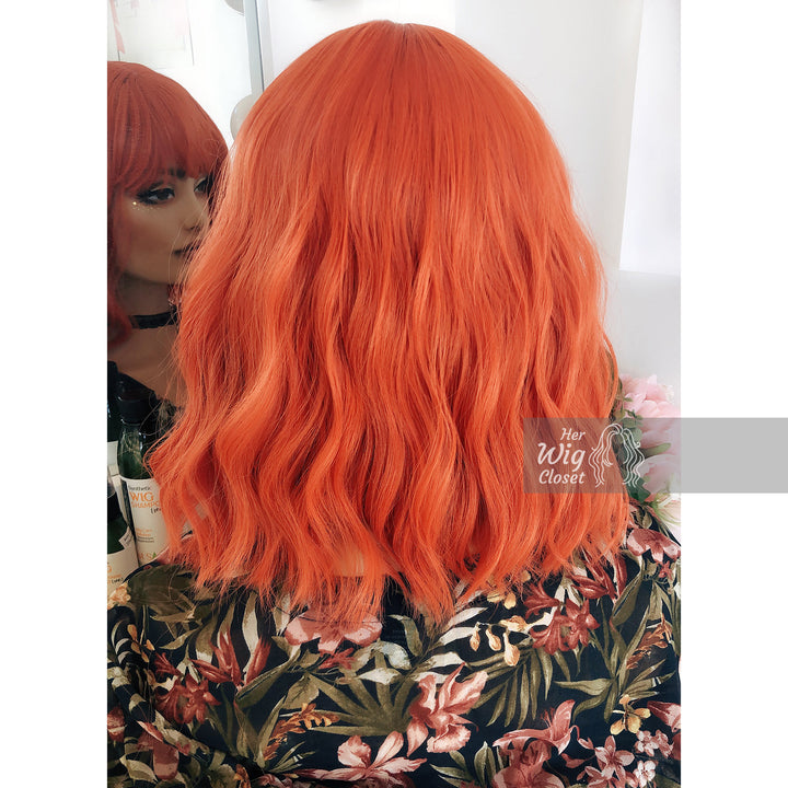 Lola | 12" Orange Wavy Bob Synthetic Wig with Bangs Her Wig Closet